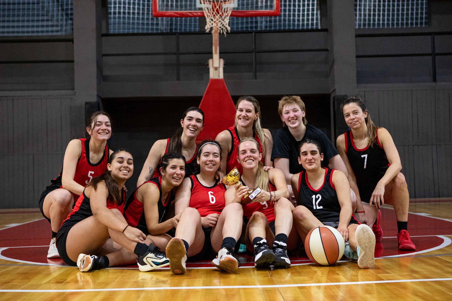 Women's basketball team coach training on indoor court